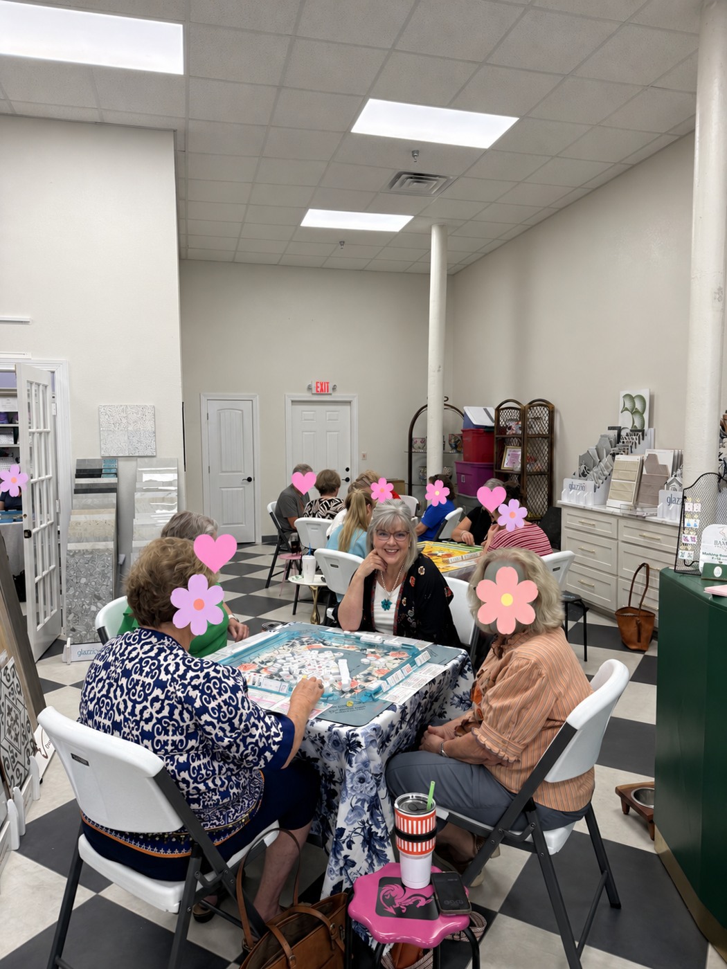 The owner at a mahjong table with other players’ faces covered